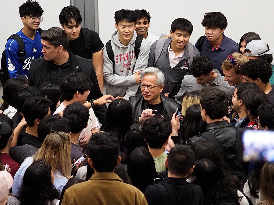 Jensen Huang surrounded by students at Stanford